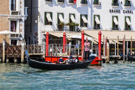 Men Gondoliers Drive Gondolas With Tourists In Venice In Italy