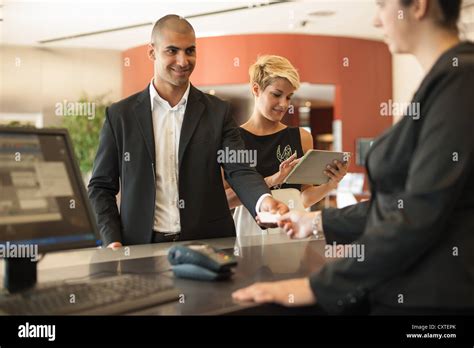 Businessman Checking Into Hotel Stock Photo Alamy