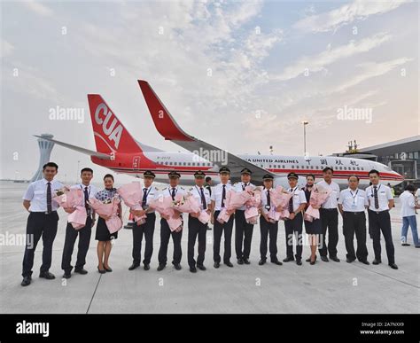 Chinese Crew Members Pose For Photos In Front Of A Jet Plane Of China