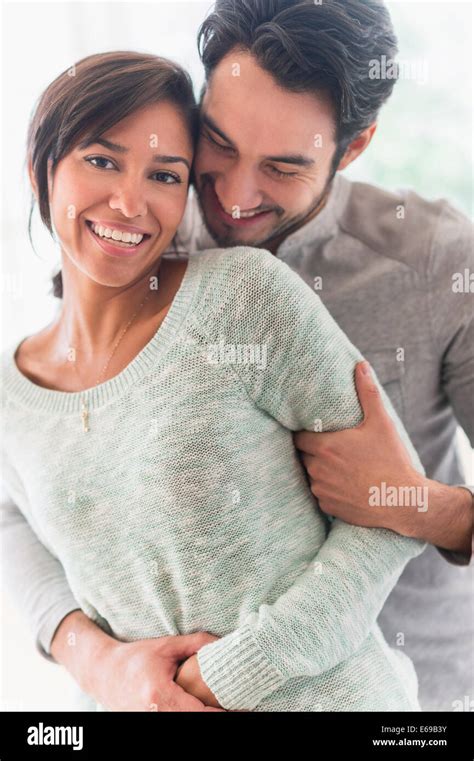 Couple Hugging Indoors Stock Photo Alamy