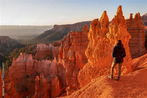 Woman Hiking On The Navajo Rim Trail Next To Thor Hammer During Sunset