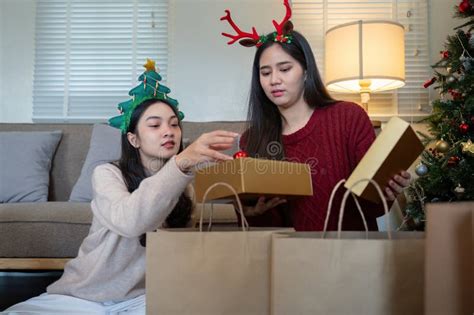 Thoughtful Lesbian Duo Preparing Holiday Packages A Festive Tradition Embraced With Care And