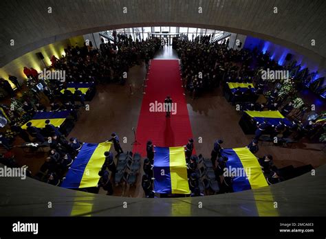 Kyiv, Ukraine. 21st Jan, 2023. Ukrainian honor guards drape flags on the caskets of seven ...