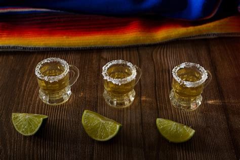 Premium Photo Tequila Shots With Salt And Lime On A Bar Table Shots