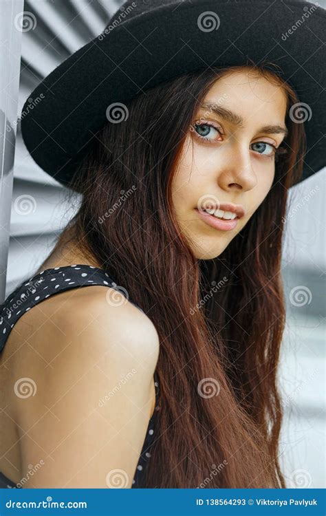 Amazing Long Haired Brunette Model Posing Near The Metal Shutters At The City Stock Image