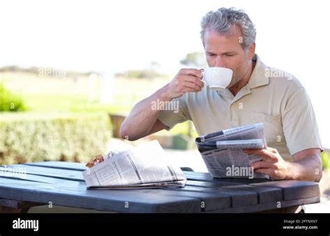 His Morning Routine A Mature Man Drinking Coffee While Reading A