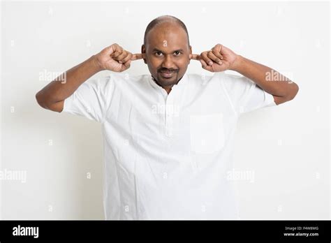 Portrait Of Mature Casual Business Indian Man Covered Ears Standing On