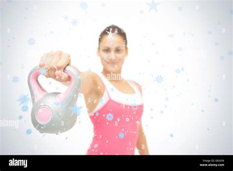Smiling Toned Brunette Showing Grey And Pink Kettlebell Stock Photo Alamy