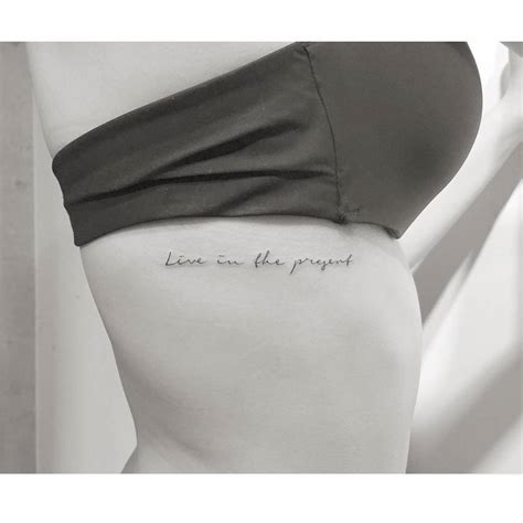 Lettering tattoo that says "live in the present"