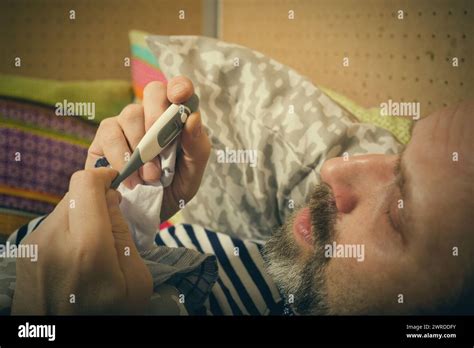 Mature Sick Man Checking Body Temperature With Thermometer Stock Photo Alamy