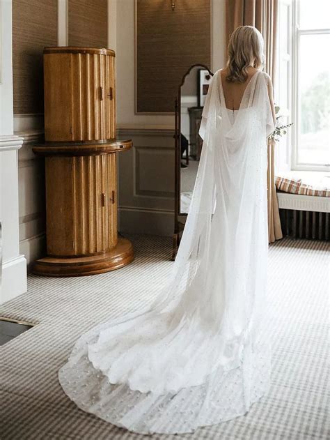 Stunning Wedding Dresses With Capes To Trail Behind You Down The