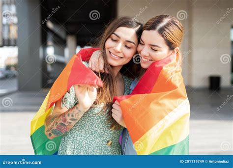 Lesbian Friends Hugging With A Gay Rainbow Flag Stock Image Image Of