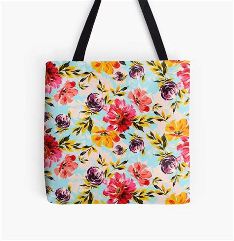 A Colorful Floral Tote Bag With Black Handles