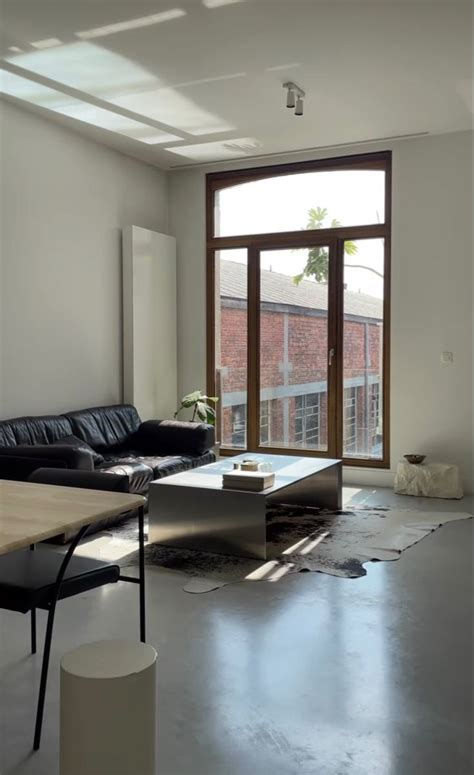 A Living Room Filled With Furniture And A Large Window