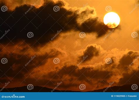 Picturesque Clouds At Sunset Sun Disk On Ornage Sky Stock Image