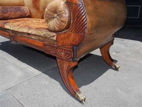 Caribbean Regency Mahogany Carved Foliage Leather Sofa On Brass Casters