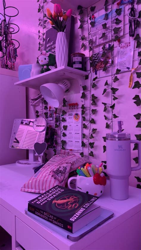 A White Desk Topped With A Book And A Cup