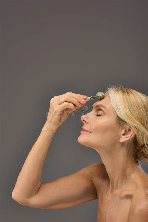 Beautiful Mature Woman Using Face Roller Stock Photo Image Of Adult