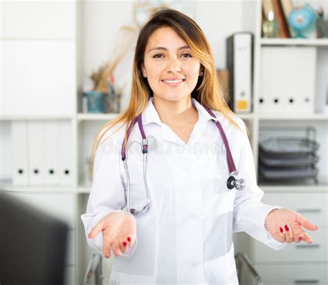 Female Doctor In Mask Welcoming To Clinic Stock Photo Image Of Table