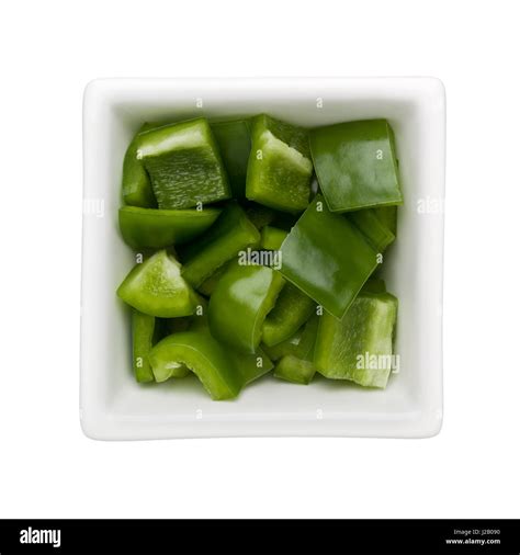 Diced Green Bell Pepper In A Square Bowl Isolated On White Background