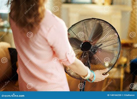 Stylish Housewife Cooling Down In Front Of Fan Stock Photo Image Of