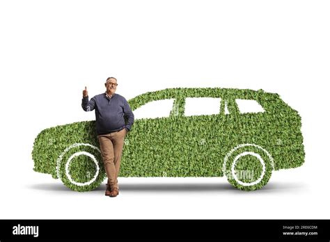 Full Length Portrait Of A Mature Man Leaning On A Suv Made Of Grass And