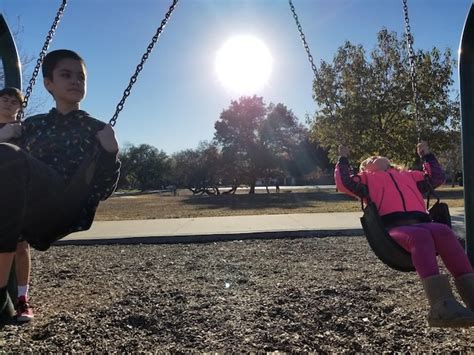 Premium Photo | Children playing on swing at park