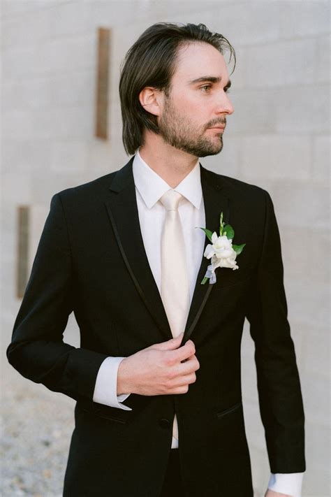 A Man In A Tuxedo With A Boutonniere On His Lapel