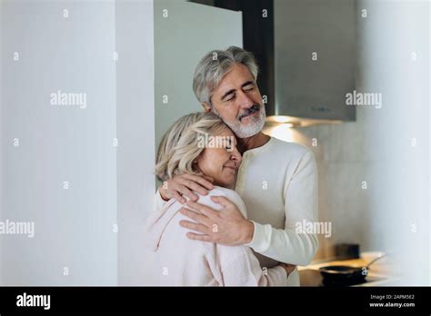 Affectionate Mature Couple Hugging At Home Stock Photo Alamy