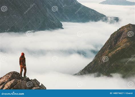 Traveler on Cliff Overlooking Mountain Clouds Alone Stock Image - Image of motivation, climbing ...