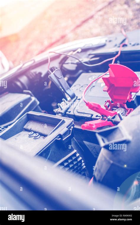 Battery Clamps Connected To The Empty Car Accumulator While Charging It