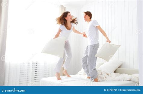 Happy Couple Jumping And Having Fun In Bed Stock Image Image Of