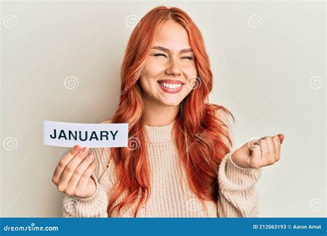 Young Redhead Woman Holding January Word Paper Screaming Proud Celebrating Victory And Success