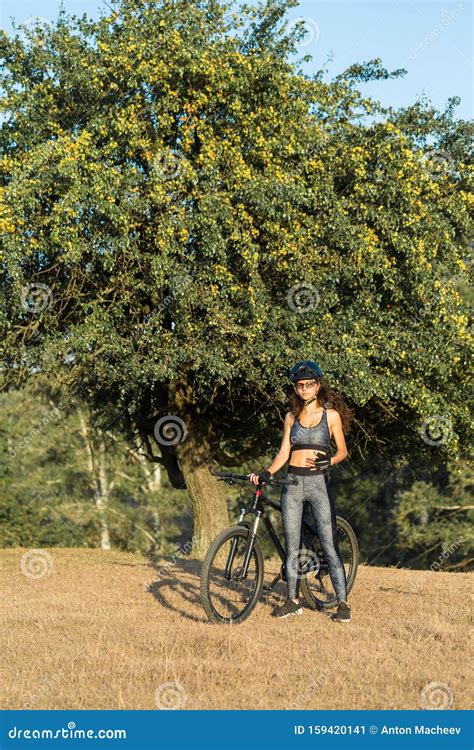 Girl On A Mountain Bike On Offroad Beautiful Portrait Of A Cyclist At