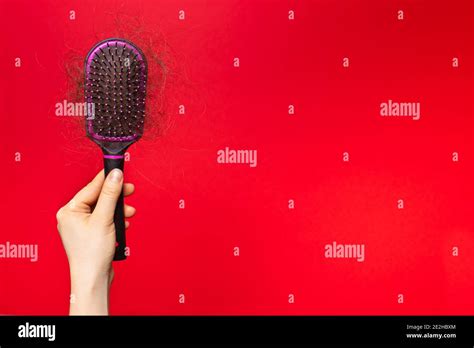 A Human Hand With Fallen Hair On A Red Background Hair Loss Hair Care