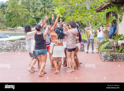 Tourists Enjoy Dancing With The Indigenous Peoples Of Cuba Near The