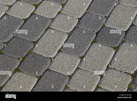 Industrial Building Background Of Paving Slabs With Overgrown Wi Stock