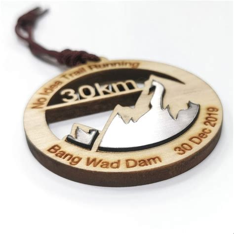 A Wooden Ornament With An Image Of A Mountain And The Words 30 Km