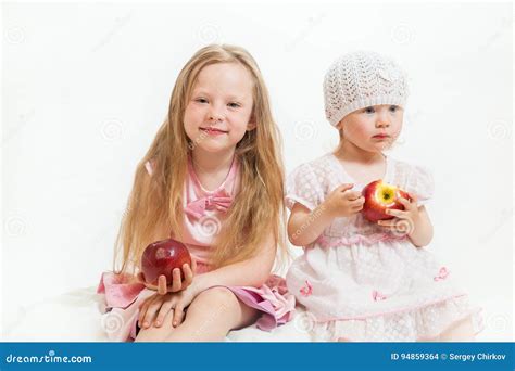 Two little girls sit stock photo. Image of smile, cheerful - 94859364