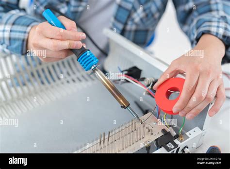 Male Hands Close Up Soldering Wires In Radiator Stock Photo Alamy