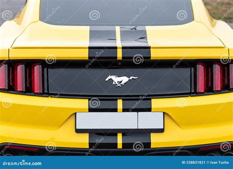 Yellow With Black Stripes Ford Mustang Muscle Car In A Parking Lot