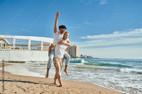 Lovely Gay Couple On Piggyback Ride At The Beach Stock Photo Adobe Stock