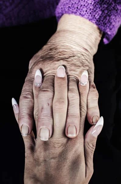 Support Hands With Crossed Fingers Of Old And Young Women Stock