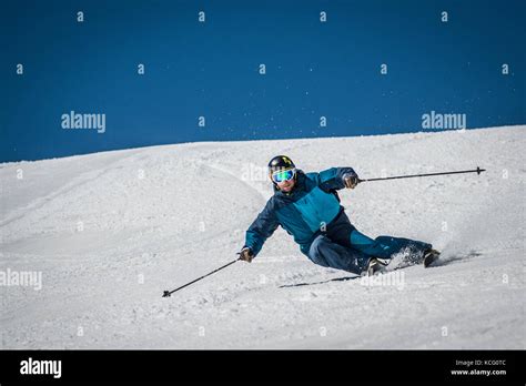 A Skier Carves A Turn On Piste In The French Alpine Resort Of