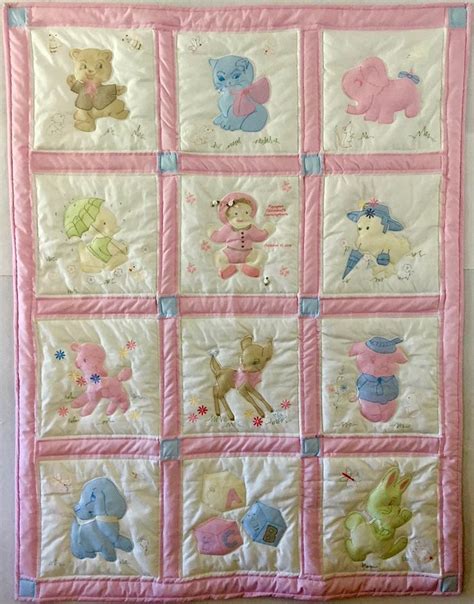 A Pink And White Baby Quilt With Teddy Bears On The Front In Pastel Colors