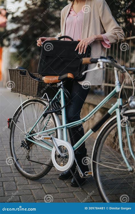 Professional Woman With Briefcase Ready To Commute By Bicycle In The