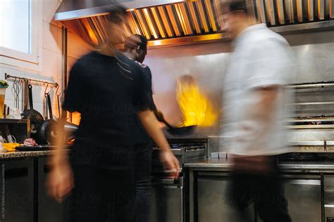 Multiethnic Men Cooking In Kitchen By Stocksy Contributor Victor