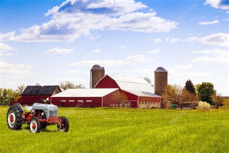 Traditional american red farm with tractor — Stock Photo #29366125