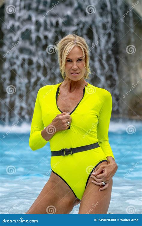 Lovely Mature Blonde Bikini Model Enjoys A Day Poolside At Home Stock