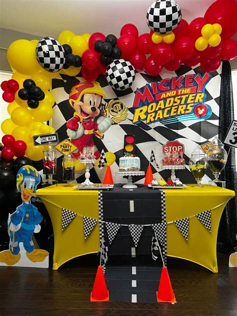 A Mickey Mouse Race Themed Birthday Party With Balloons And Streamers